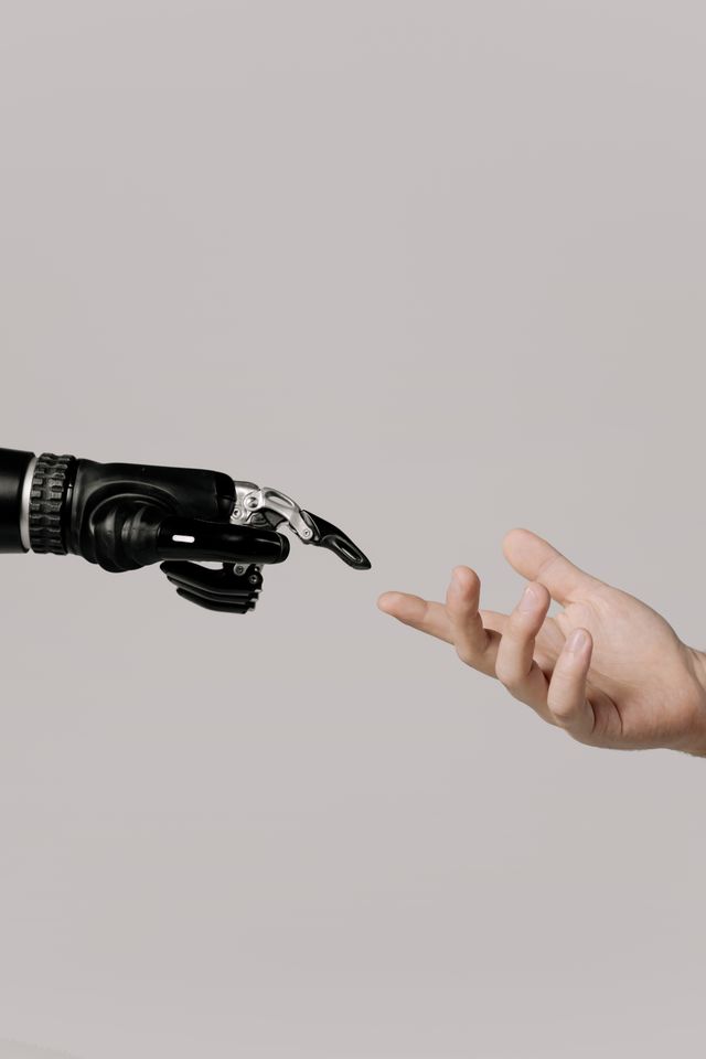 pexels-cottonbro-6153343 image of a robot finger touching human finger