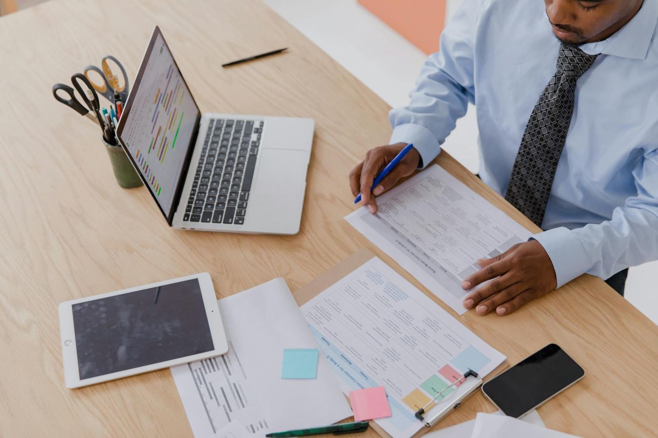 A communications leader at a mission-driven organization reviewing a PR strategy framework at a desk.
