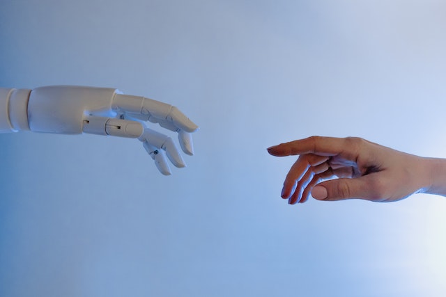 robot finger human finger trying to touch