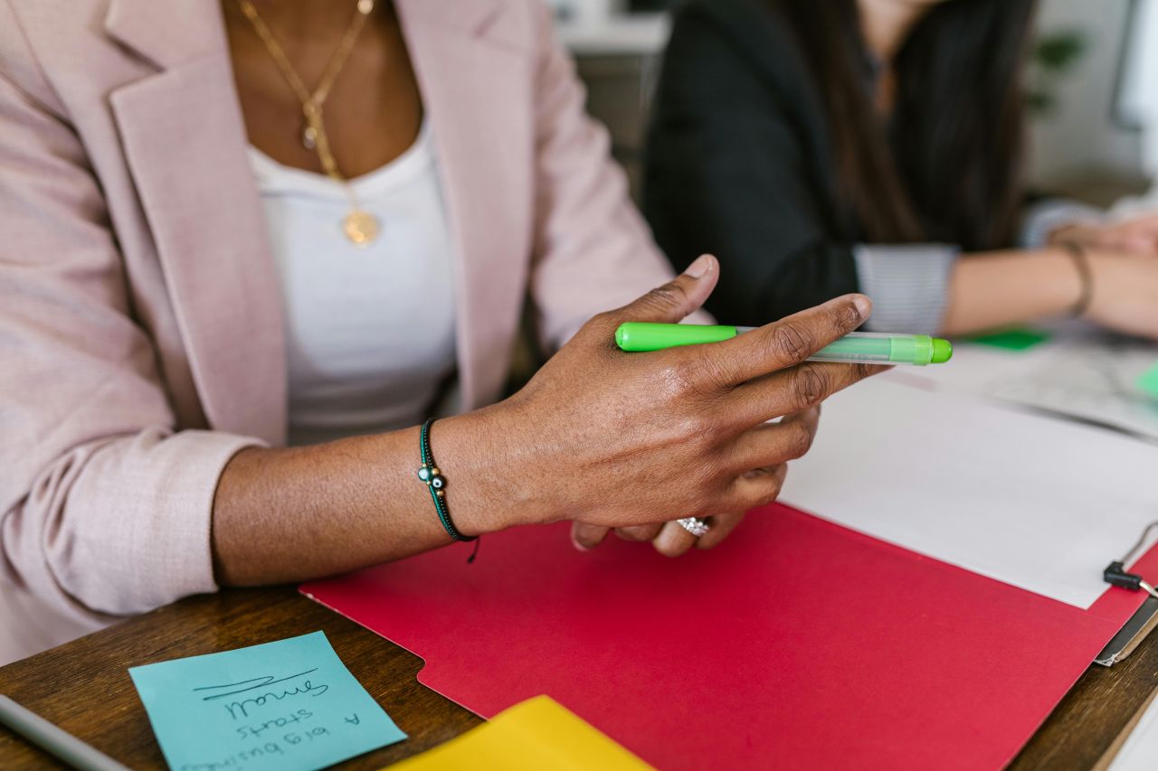 A communications professional building a PR story library by reviewing notes from a stakeholder interview