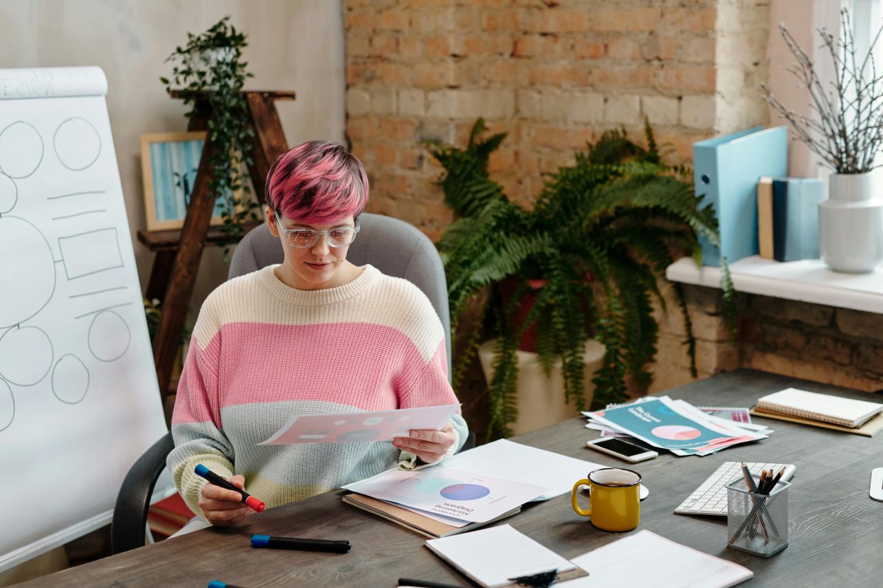 Mission-driven organization communications leader reviewing PR strategy notes at desk