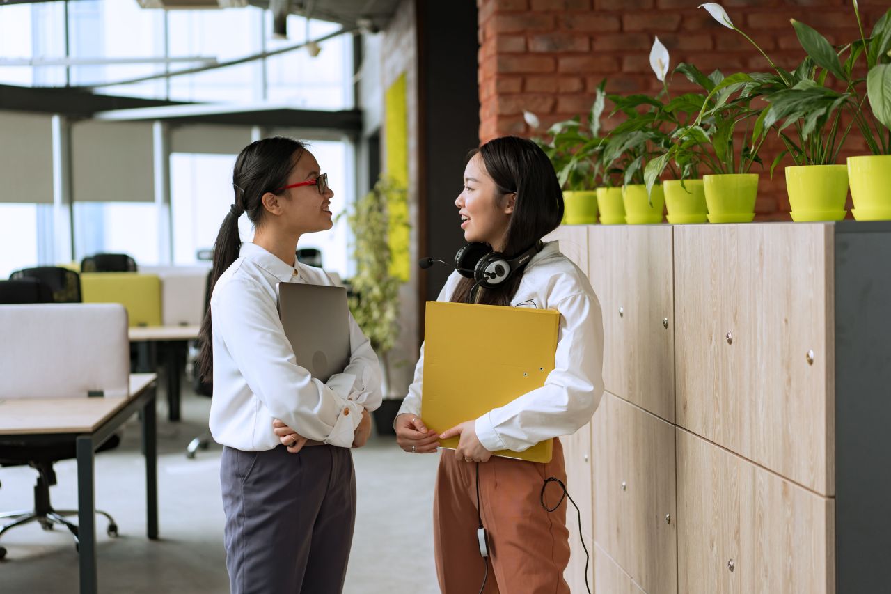 Two professionals in conversation representing what does PR stand for beyond press releases. Photo by Mikhail Nilov via Pexels.